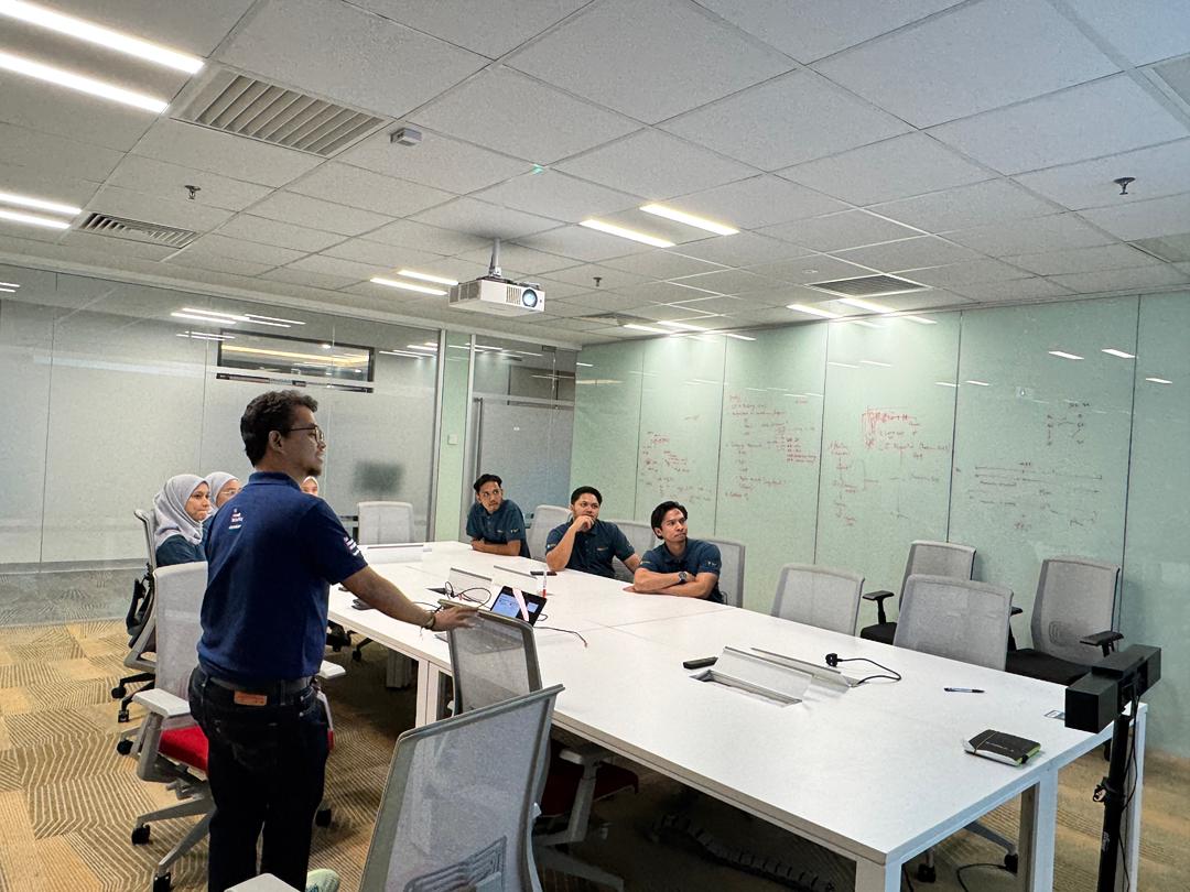 Petronas Carigali PSM training participants reviewing flip chart materials during a Kaizen exercise
