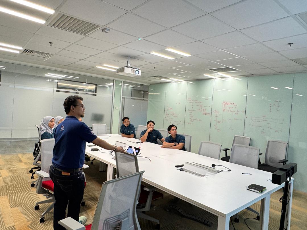 Petronas Carigali PSM participants reviewing Kaizen concepts on a whiteboard during training at PECC Kerteh