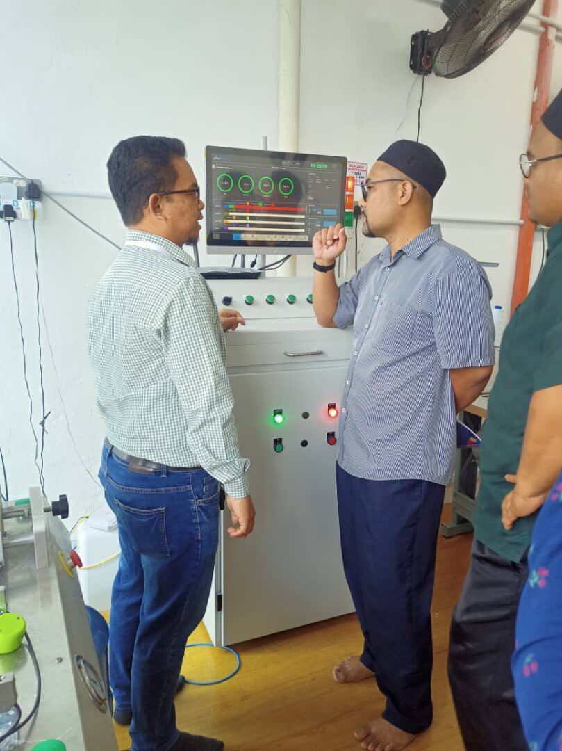 Factory line discussion during manufacturing process improvement visit