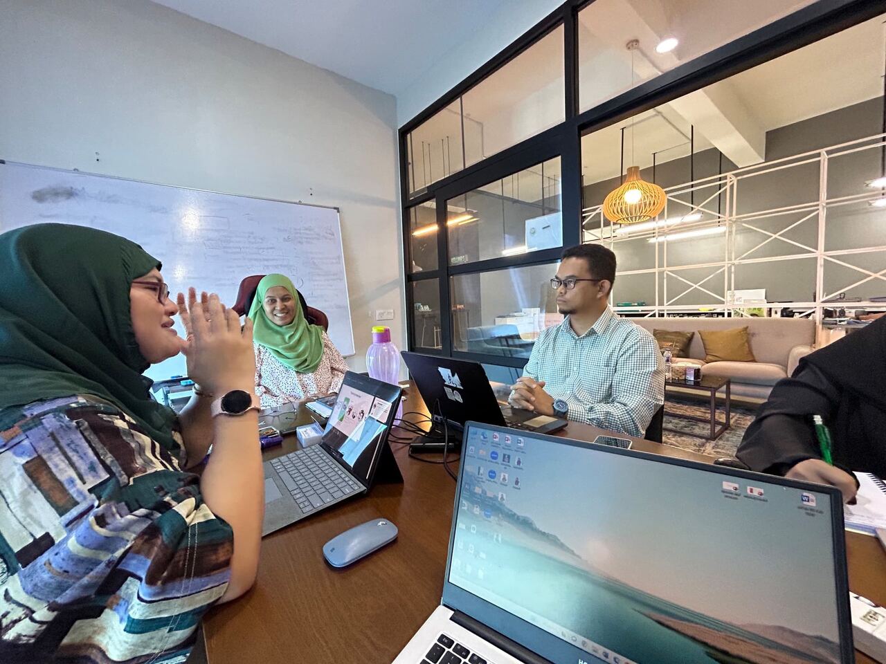 Husni Halim leading a table discussion during a manufacturing consultation